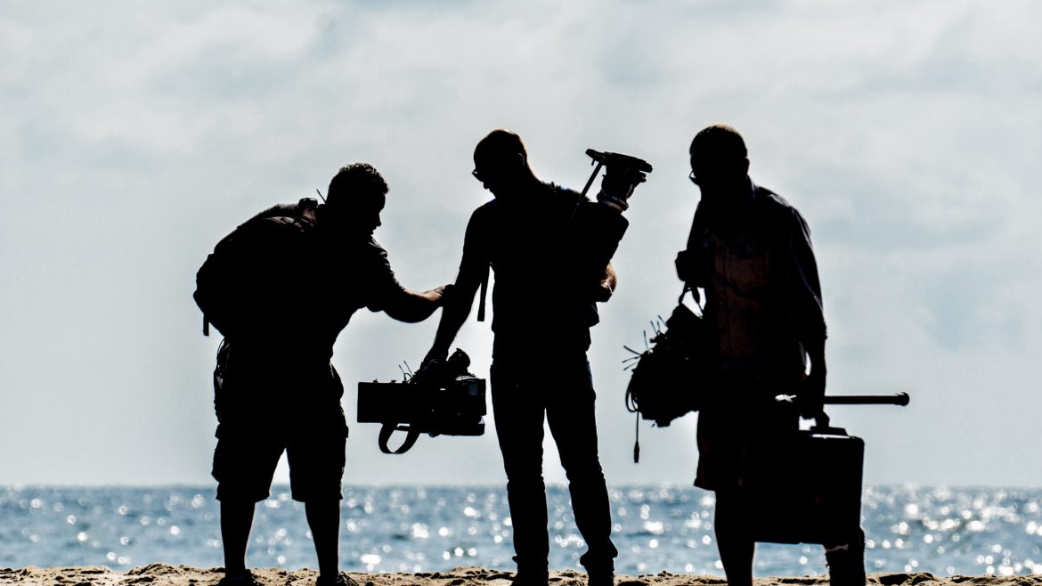 A video production crew is filming on the beach | Crew Connection